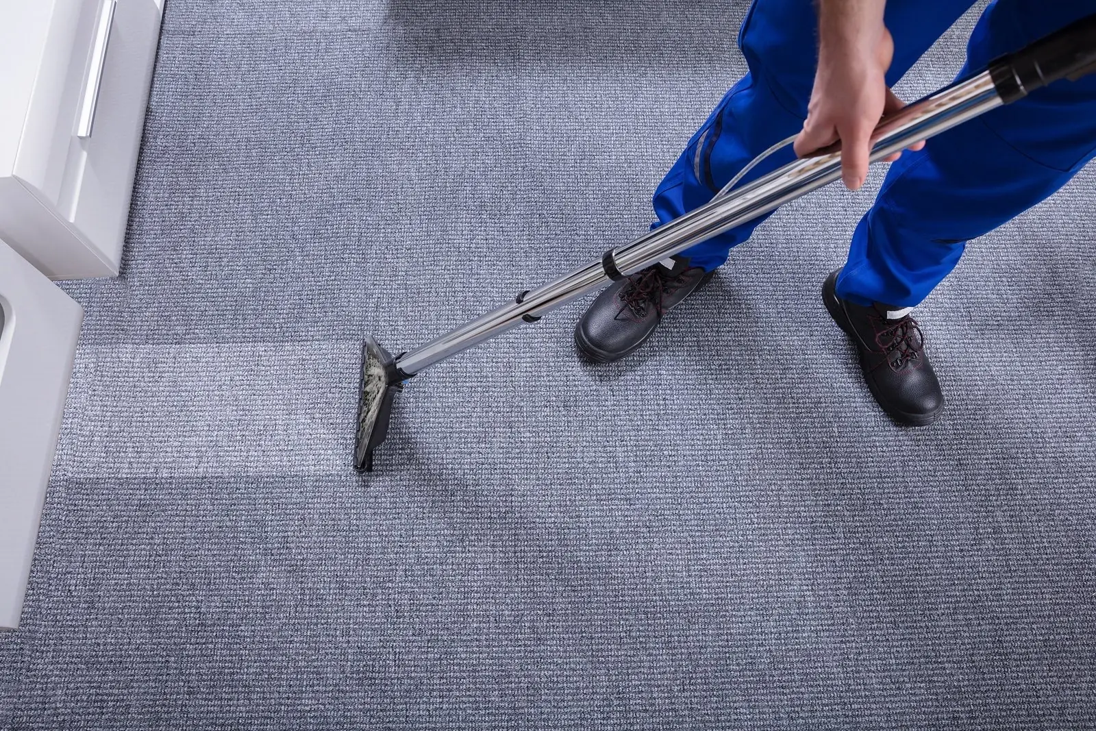 Before carpet cleaning: stained, worn carpet