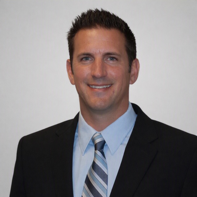 Brad, founder of Ventura Power Washing, smiling in a dark suit and light blue shirt